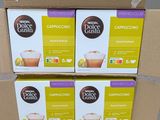 three boxes of coffee sitting on top of a table next to each other