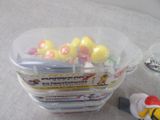 a plastic container filled with assorted toys on a table