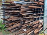 a large pile of wood sitting in front of a building