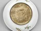 an image of a plate with a gold rim sitting on a table