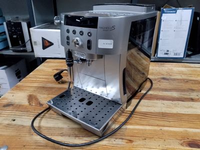 a coffee machine that is sitting on a wooden table