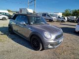 a silver mini cooper parked in a parking lot