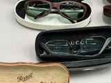 several pairs of sunglasses are in a case on a table