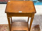 a small wooden table with a drawer on it
