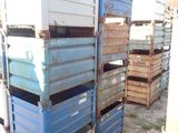 many crates stacked on top of each other in the dirt