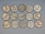 a bunch of silver coins sitting on top of a white surface
