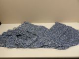 a blue blanket on a white table in a room