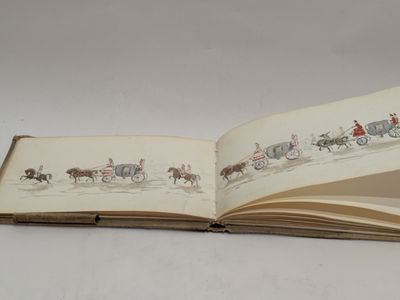 an open book with a picture of a horse drawn carriage on it