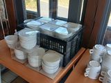many plates and bowls on a table in a restaurant