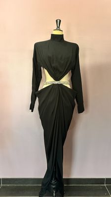 a black dress with a gold belt on a mannequin mannequin mannequin mannequin mannequin mannequin mannequin manne