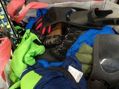 a pile of skis and ski poles in a bag