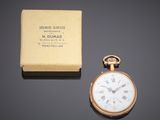 an antique gold pocket watch with a box on a table