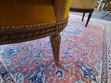a yellow chair sitting on top of a rug in a living room