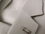 a close up of a suit jacket with a tie bar