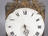 a clock that is sitting on a table with a wire
