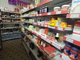 many shelves of food in a grocery store that is empty