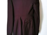 a close up of a purple suit on a hanger