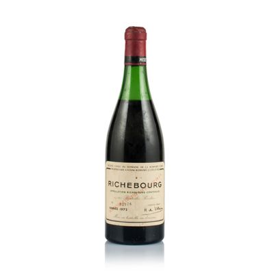 a close up of a bottle of wine on a white surface