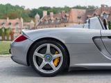 the silver sports car is parked in front of a large building