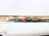 a close up of a knife on a white surface