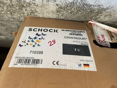 a cardboard box with a sticker on it sitting on the ground