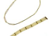 a close up of a bracelet and a necklace on a white surface