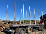 a truck that has a bunch of logs on the back of it