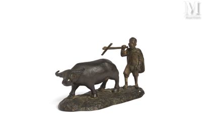bronze figurine of a man plowing a bull with a hammer