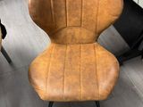 a chair that is next to a piano in a room
