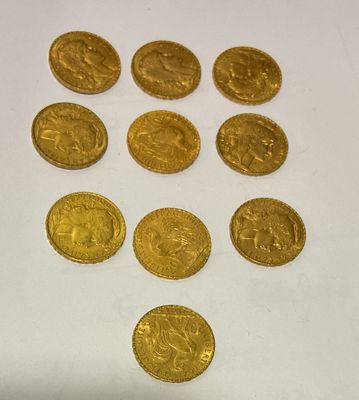 a close up of a bunch of gold coins on a white surface