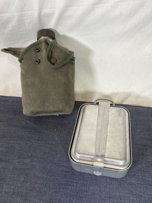a lunch box and a lunch bag sitting on a bed