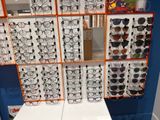 many glasses on display on the wall in the store