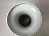 a close up of a white cup on a table
