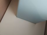 a white box with a blue lid sitting in a box