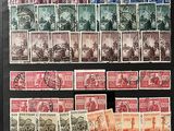 a black framed picture of a collection of stamps on a table