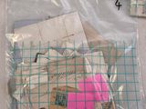 a bag of stamps and a ruler on a table
