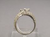 an image of a diamond ring on a clear stand