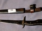 two knives that are laying on a table