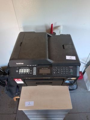a printer sitting on top of a stack of boxes