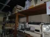 many sewing machines that are on a shelf in a room