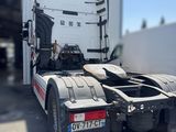 a semi truck that is parked in front of a building