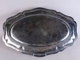 an antique silver plate on a white table with a white background