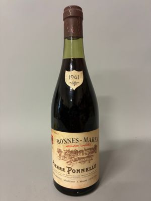 an old bottle of wine sitting on top of a table