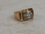 an image of a gold and diamond ring on a table