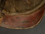 a close up of a brown hat with a leather band