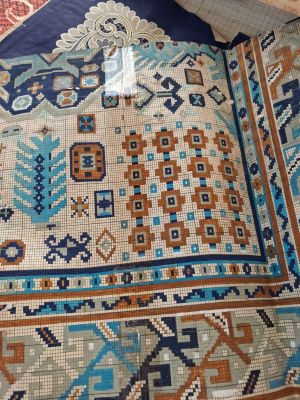 an image of a blue and orange rug on a bed
