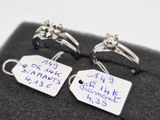 pair of wedding rings with price tags on them on display