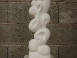 a white sculpture sitting on top of a wooden table