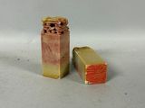 two pieces of soap sitting next to each other on a white surface
