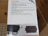 packaging of a black and white stove top oven sitting on top of a cardboard box